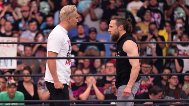 Kazuchika Okada and Bryan Danielson stare each other down in the ring